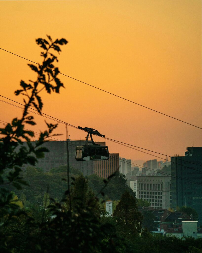 Namsan cable car ascending the mountain with city views below