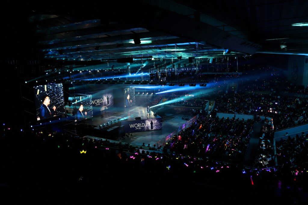 K-pop concert crowd with colorful lightsticks