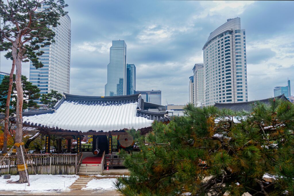 Bongeunsa Temple traditional Buddhist architecture with Gangnam skyscrapers in background