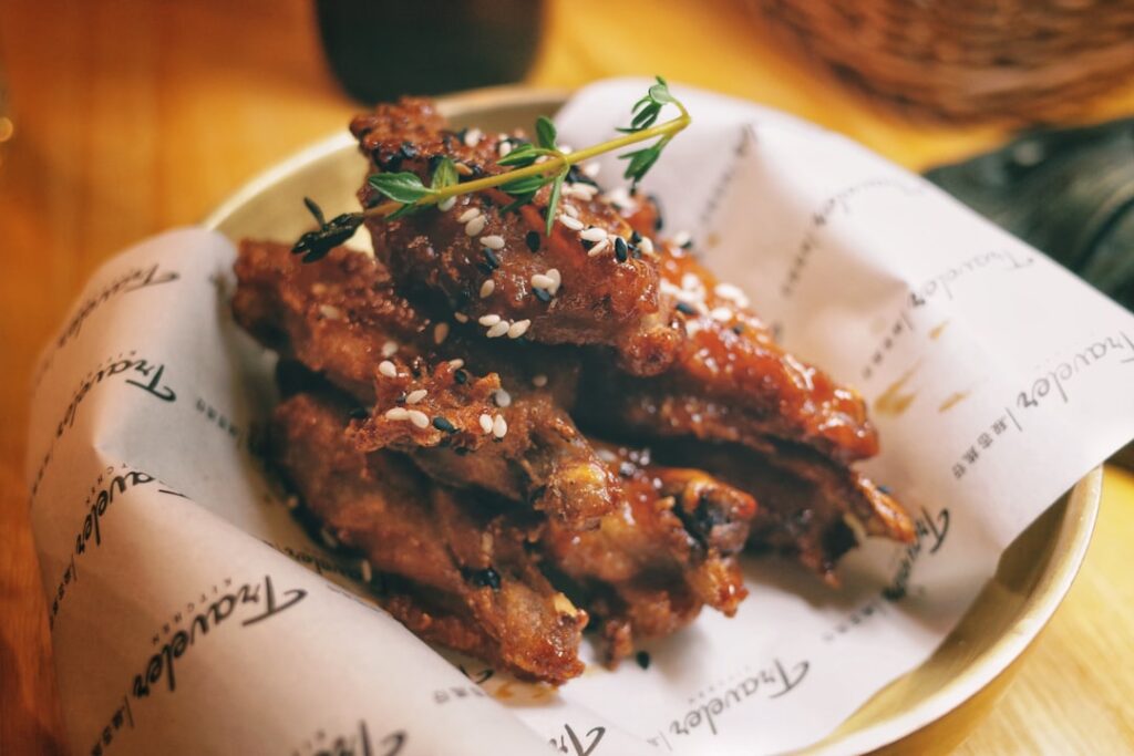 a white plate topped with meat covered in sauce