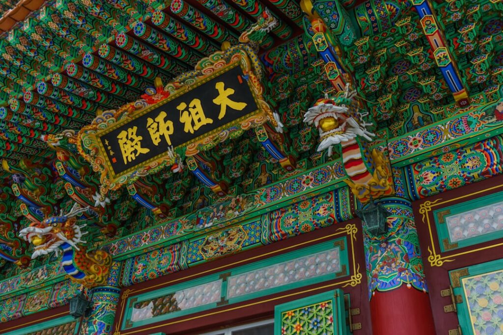 Ornate traditional east asian temple roof with dragon decorations.