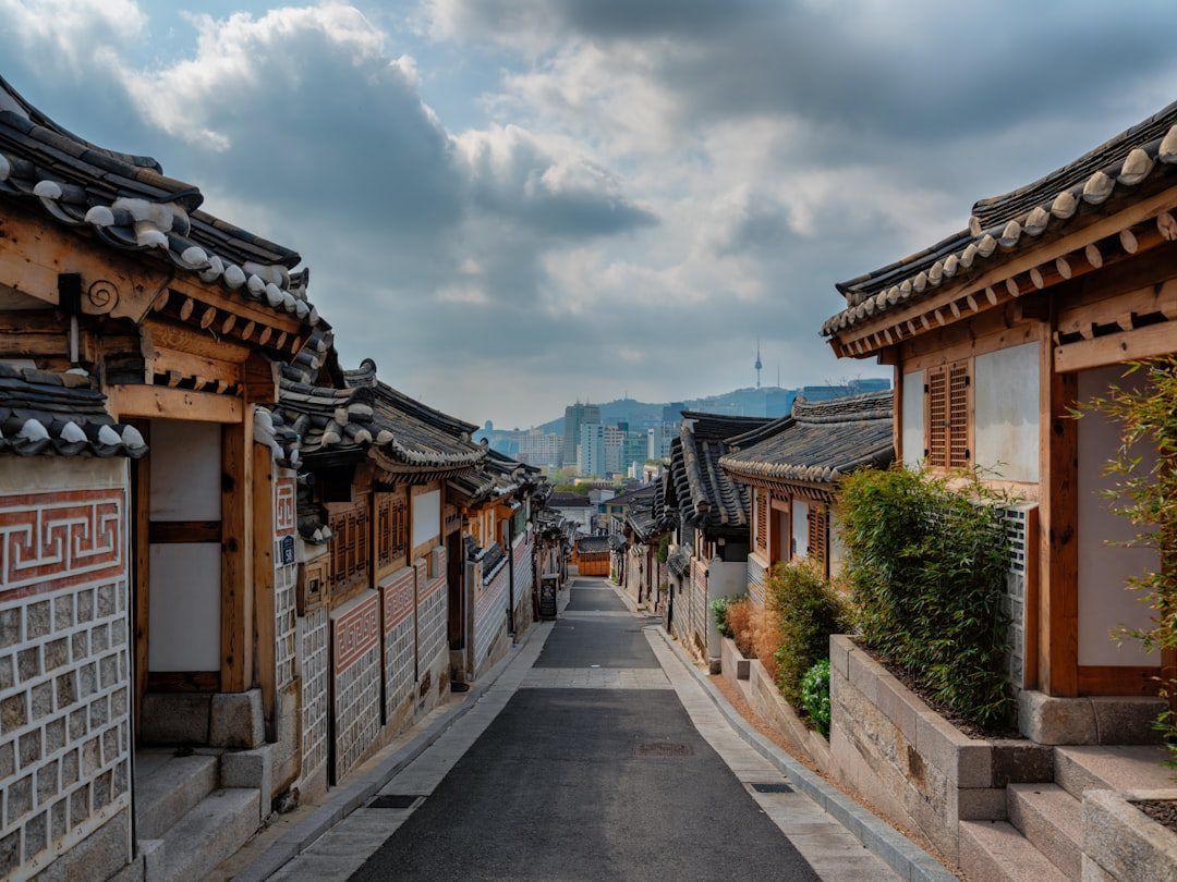 a street lined with wooden buildings under a cloudy sky