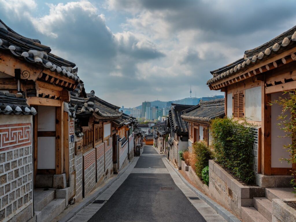 a street lined with wooden buildings under a cloudy sky