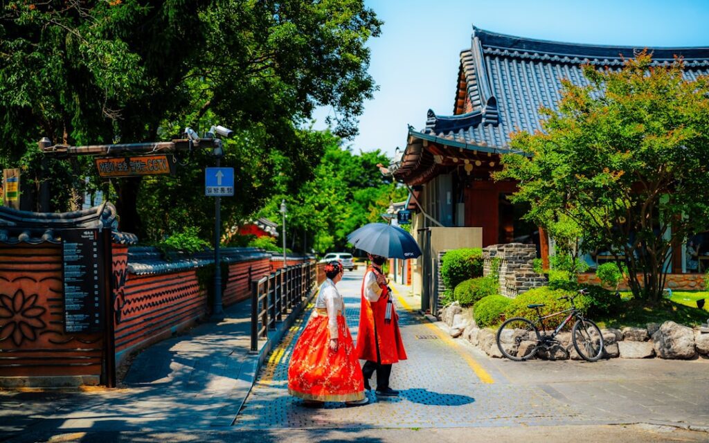 A woman walking down a street holding an umbrella