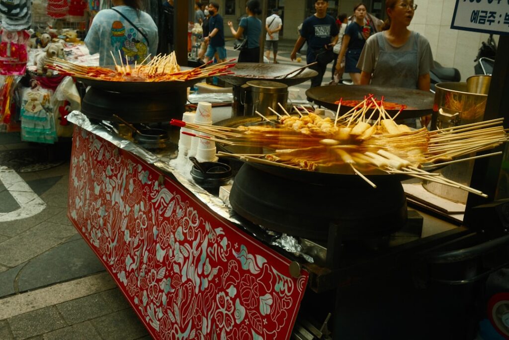 a street vendor selling food on sticks