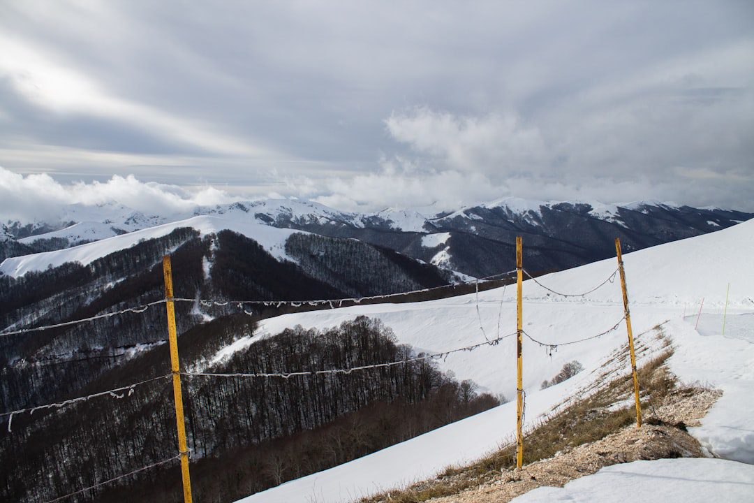Snowy mountain range with dramatic cloudy sky